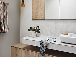 Timber Neutral Bathroom with Brown Wall and Timber Cabinets and Sleek White Basin and Sink